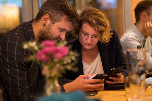 Vorstandsvorsitzende Florian Pitschel und Amelie Montigel schauen gemeinsam auf ein Smartphone